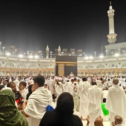 Night view of pilgrims gathered around the Kaaba in Mecca, Saudi Arabia during Hajj.