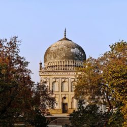 Explore the grandeur of a Qutb Shahi Tomb amidst nature in Hyderabad, India.